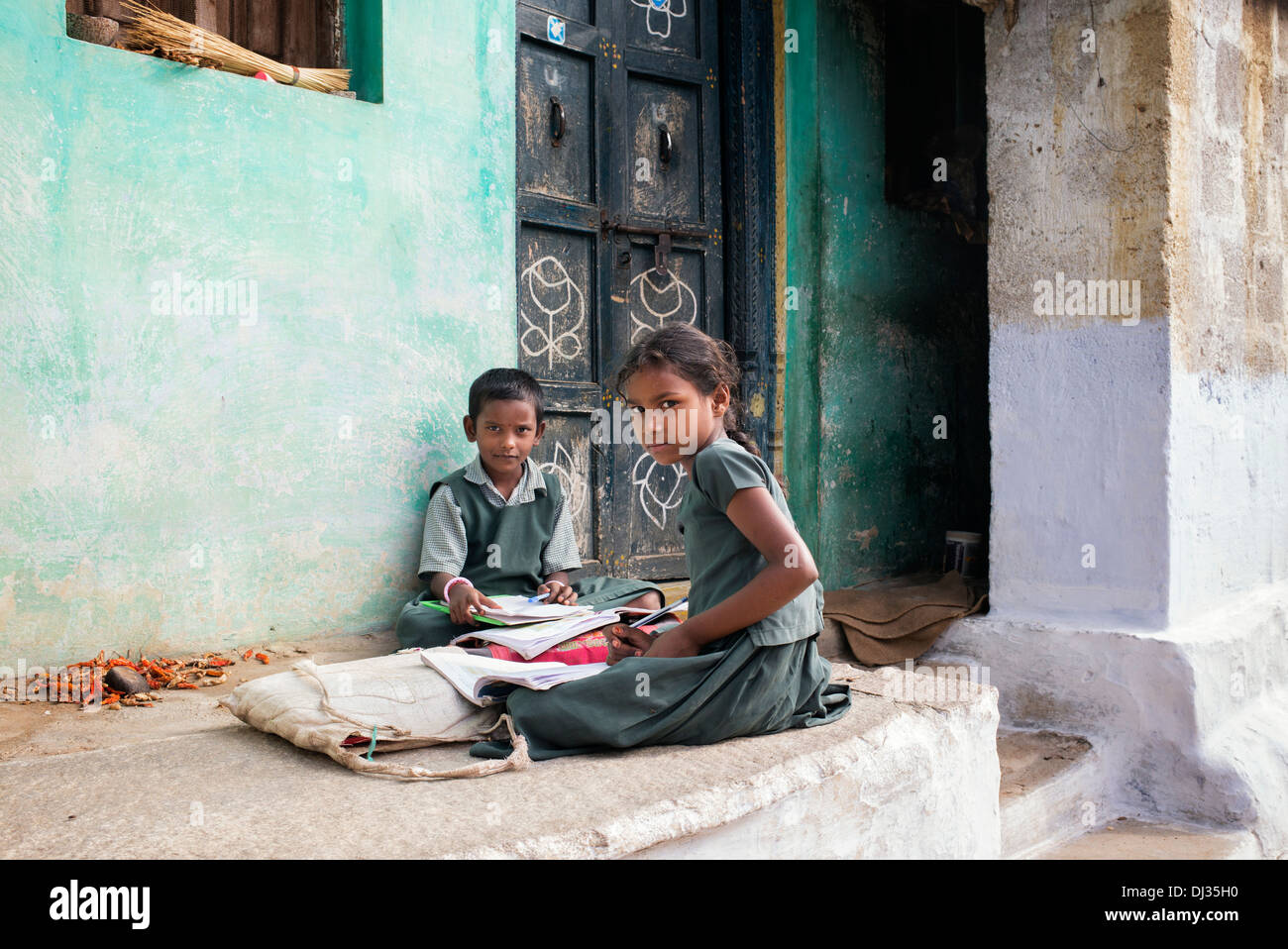 Young Indian girls doing school work outside their rural Indian village home. Andhra Pradesh, India Stock Photo