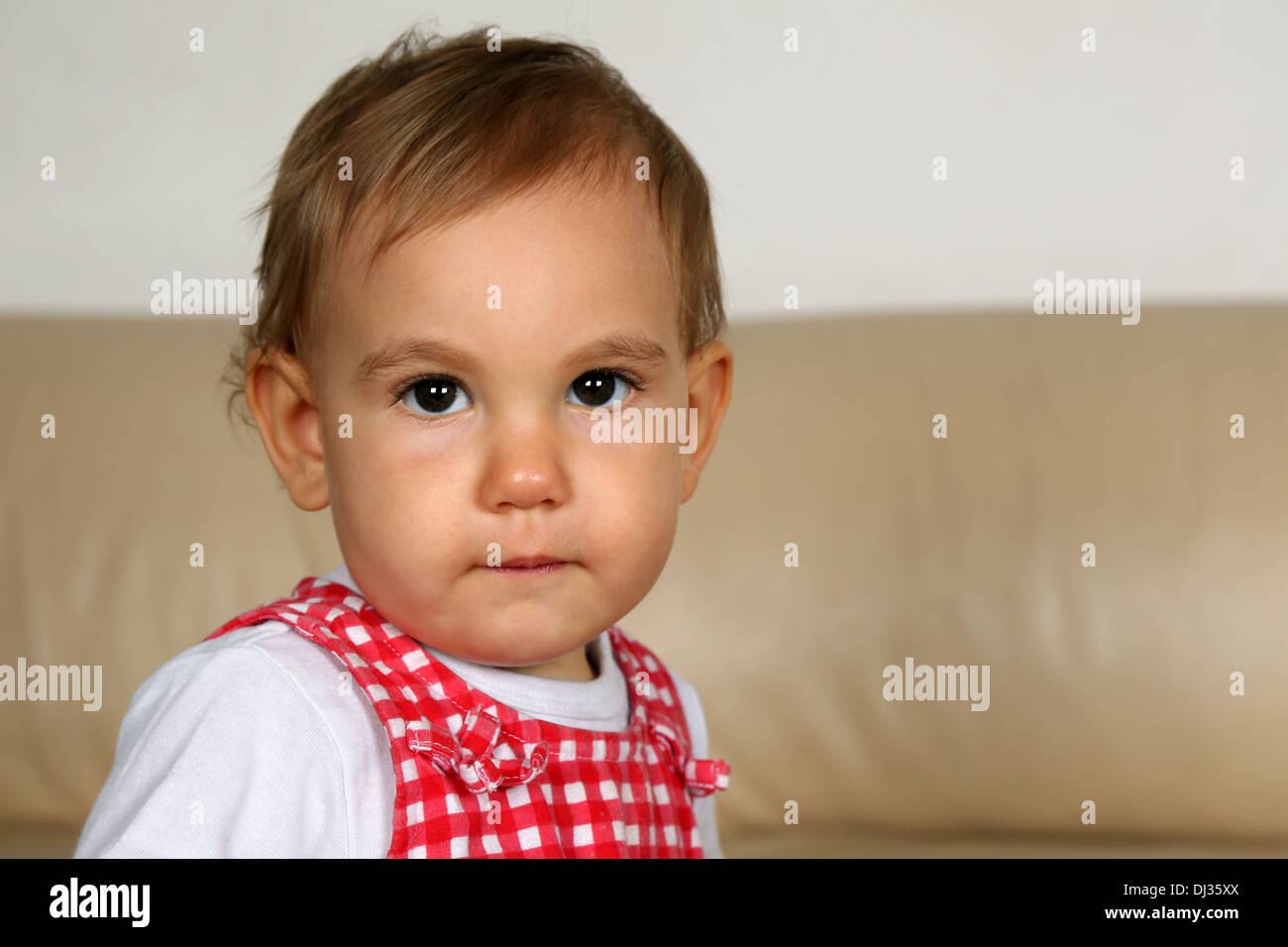 Portrait of a little baby, looking with huge eyes into camera Stock Photo