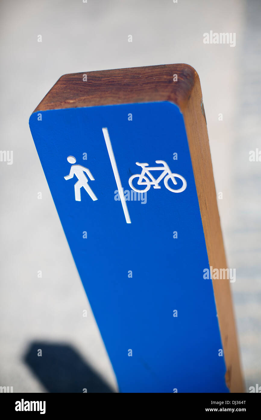 Blue signpost indicating cycle lane and walk way in Brooklyn, New York on a sunny day. Stock Photo