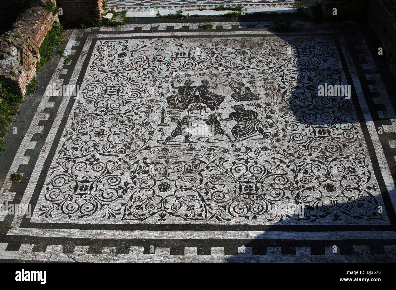 Italy. Ostia Antica. House of Bacchus and Ariadne. Floor mosaic. Bacchus and his wife Ariadne and Pan and Eros fighting. Stock Photo