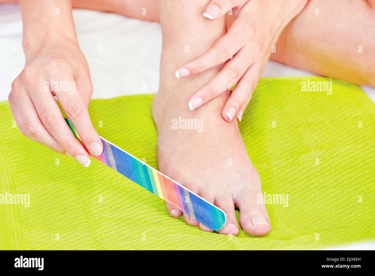 feet beauty treatment with nail file Stock Photo