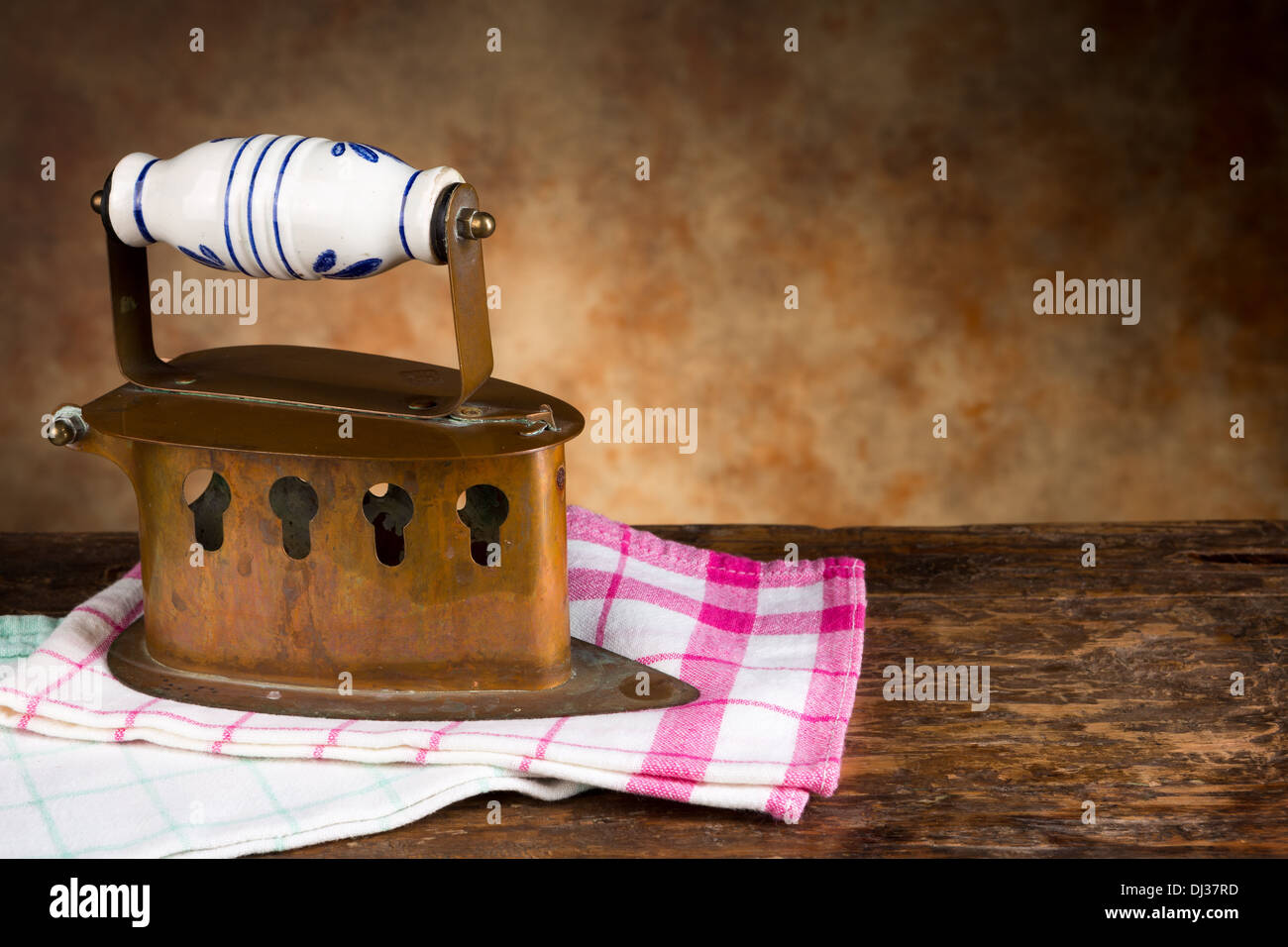 Beautiful vintage iron resting on clean old-fashioned towels Stock Photo