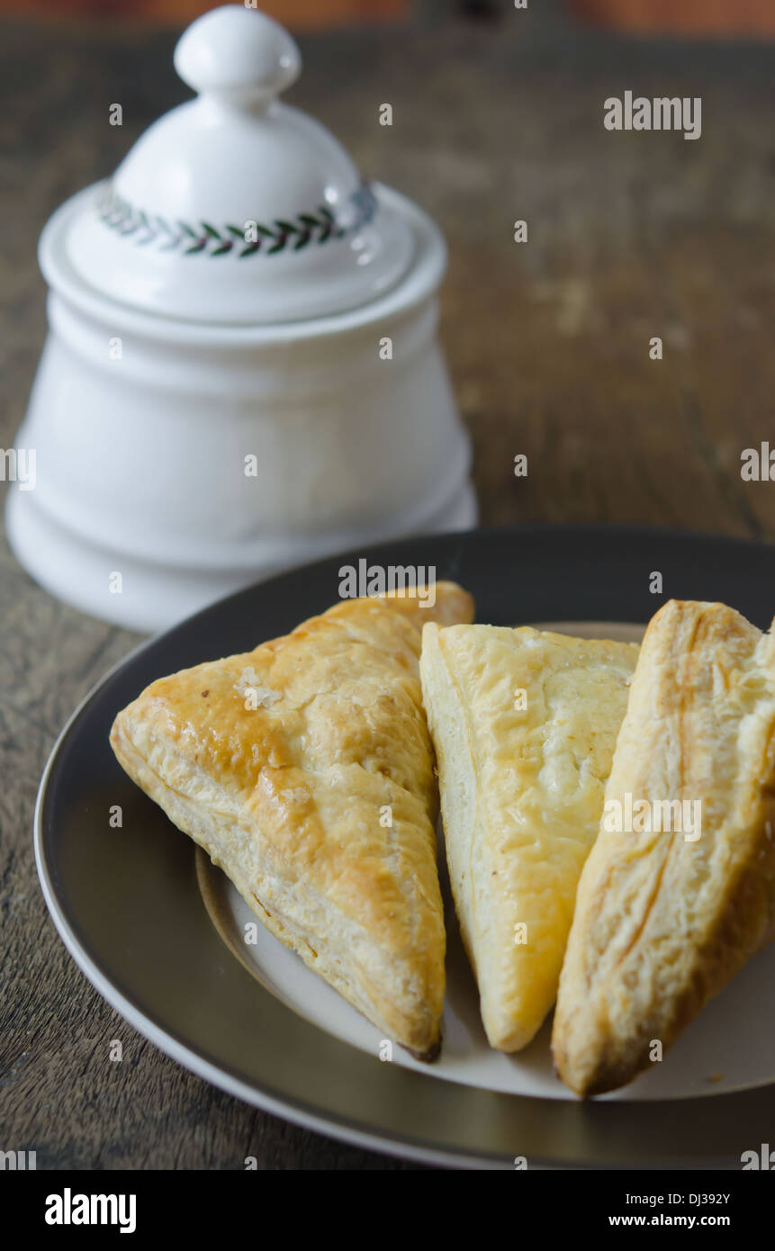 Puff pastry on the plate over wooden background Stock Photo