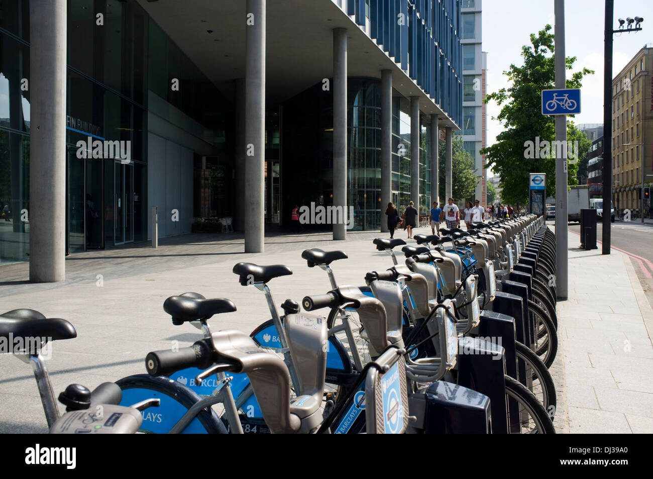 A row of Boris bikes, Barclay's Cycle Hire public bicycle sharing scheme  outside the Blue Fin Building, Bankside, London, UK. Stock Photo