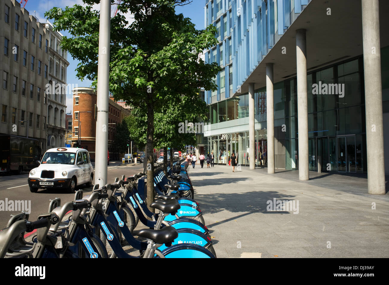 A row of Boris bikes, Barclay's Cycle Hire public bicycle sharing scheme  outside the Blue Fin Building, Bankside, London, UK. Stock Photo