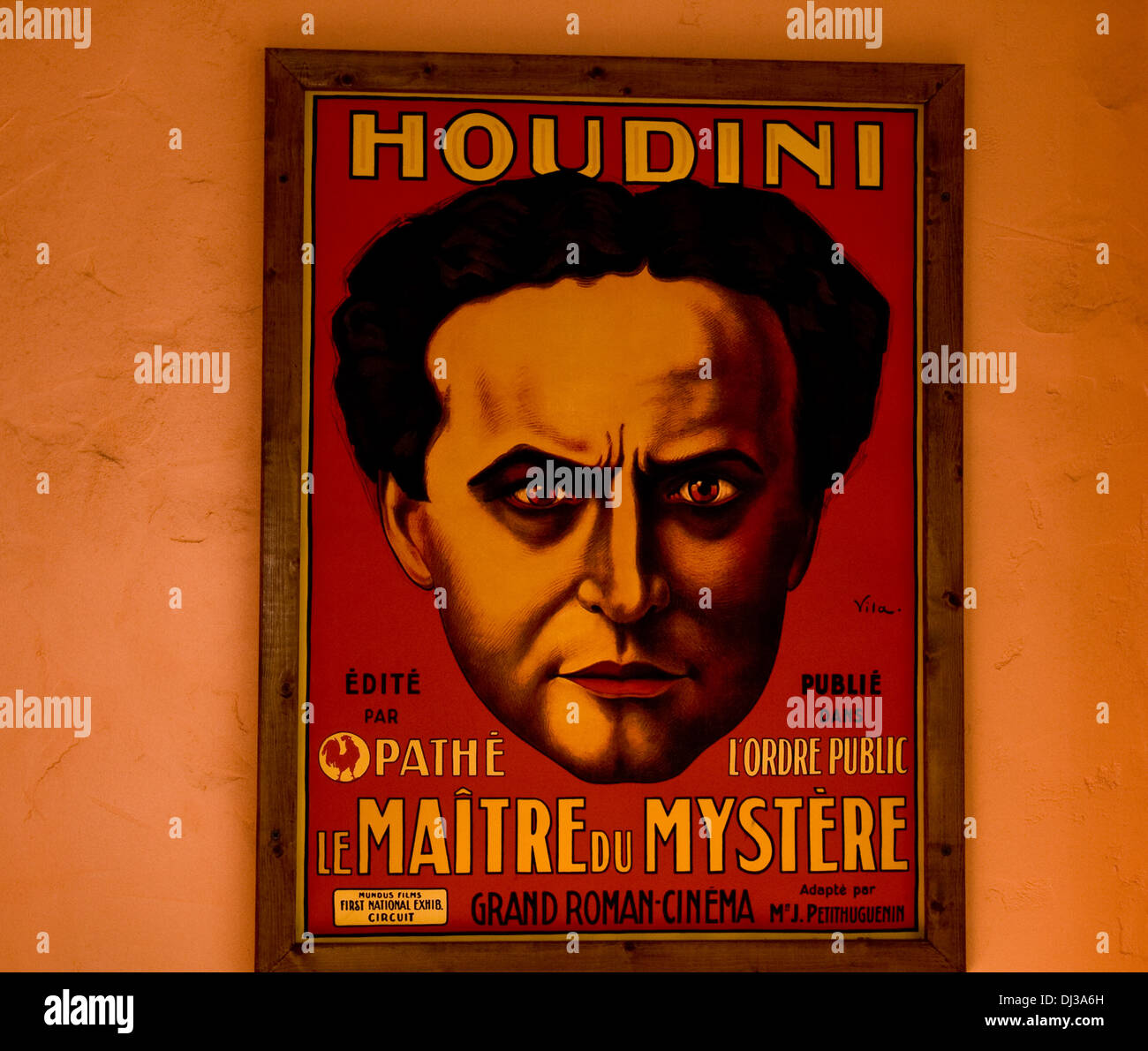 Old poster of Harry Houdini on the wall Stock Photo