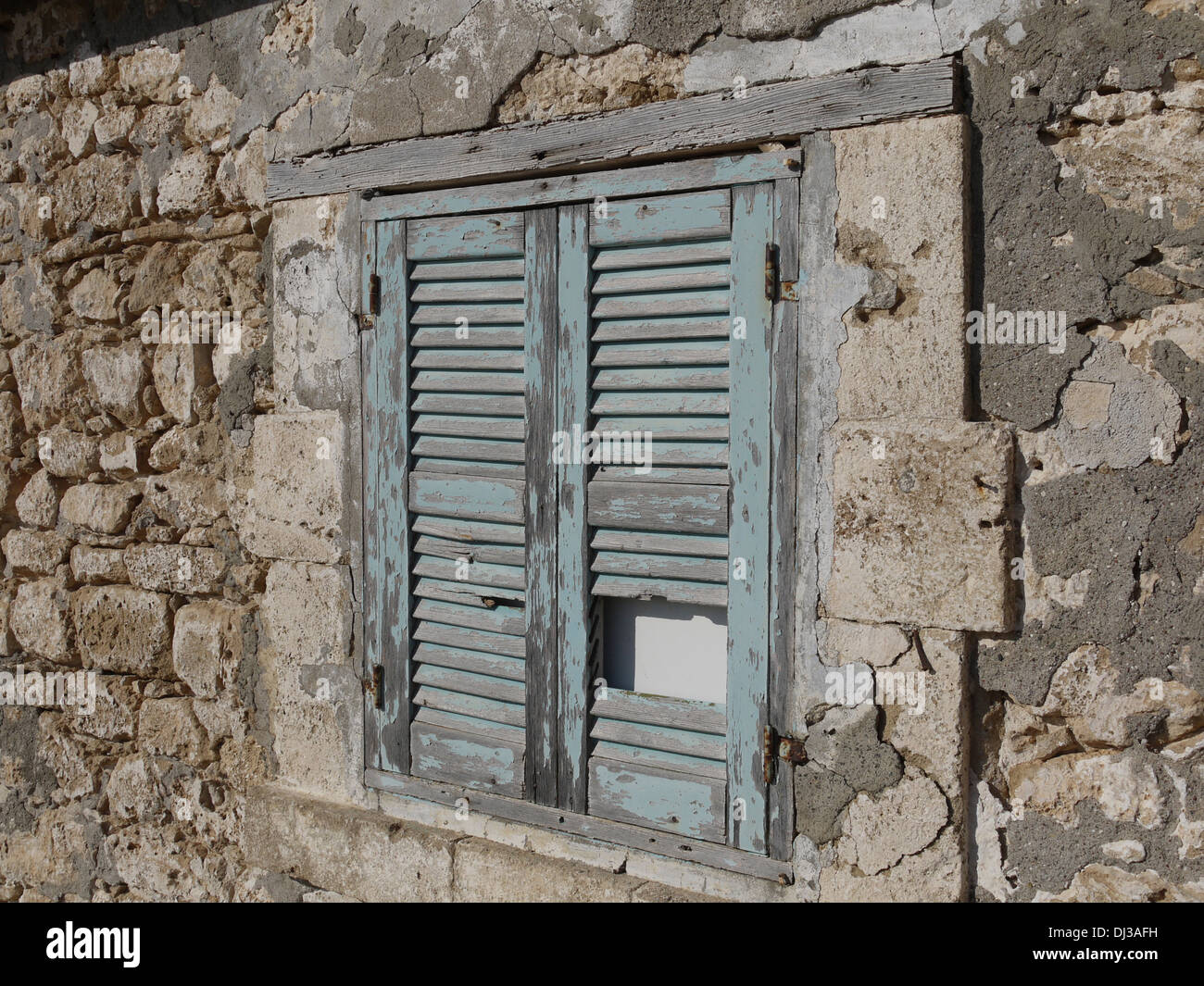 Shuttered window set in a stone wall Stock Photo - Alamy