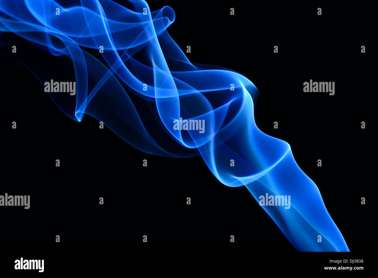 Blue smoke on the black background. Smooth blue waves of smoke. Stock Photo