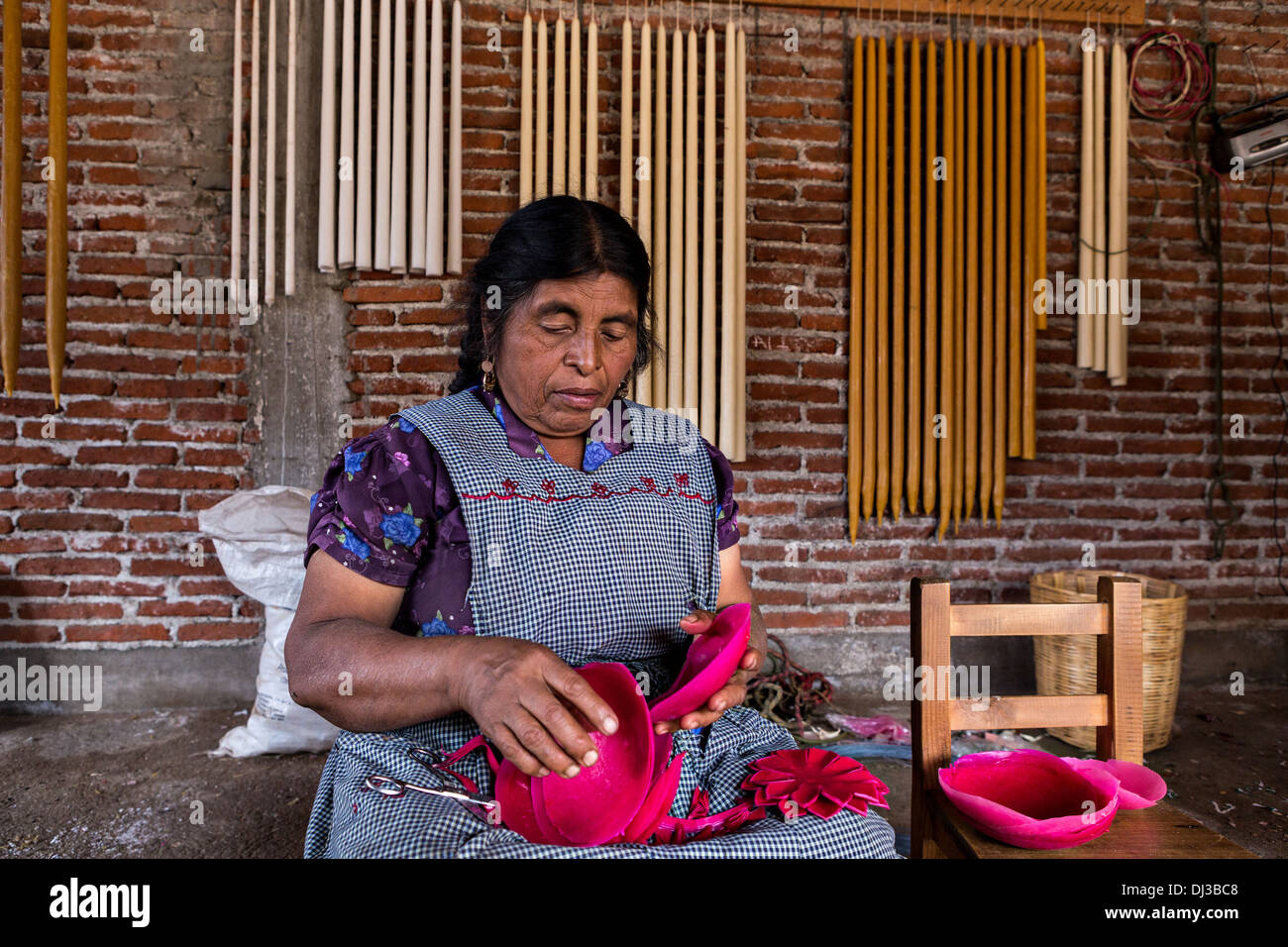 A Zapotec indigenous woman creates bees wax flowers for the Day of the Dead festival known in spanish as Día de Muertos. Stock Photo