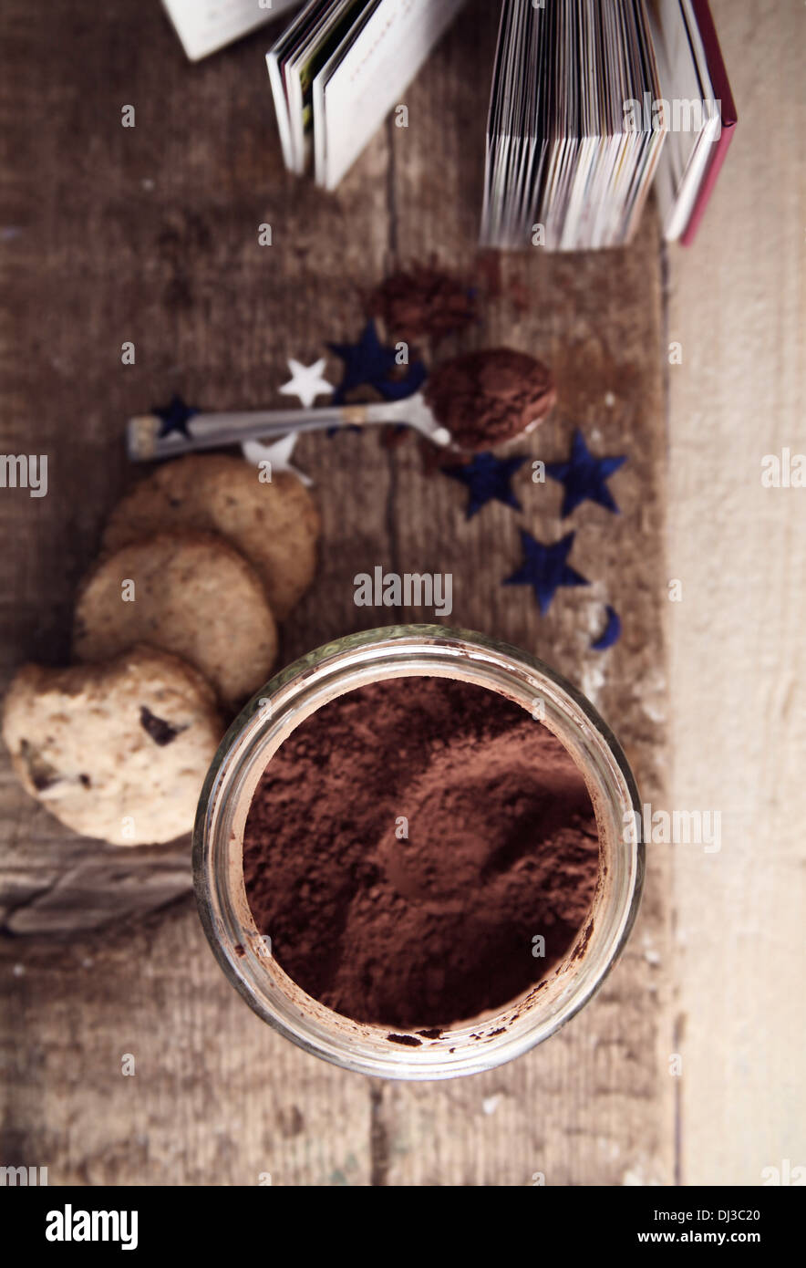 Toned image, cocoa, spoon, cookies and recipe book , wooden background Stock Photo