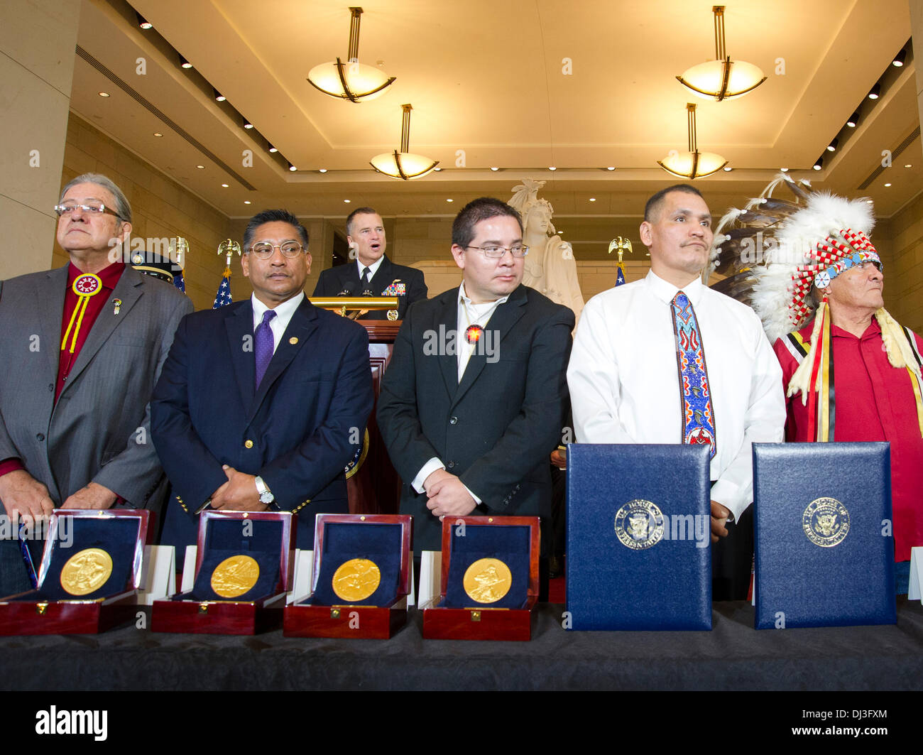 Representatives of Native American tribes stand during the Congressional Gold Medal Ceremony Honoring Native American Code Talkers in Emancipation Hall at the US Capitol Nov. 20, 2013 in Washington, DC . The Congressional Gold Medal was awarded to Native American code talkers for their valor and dedication during World War I and World War II. Stock Photo