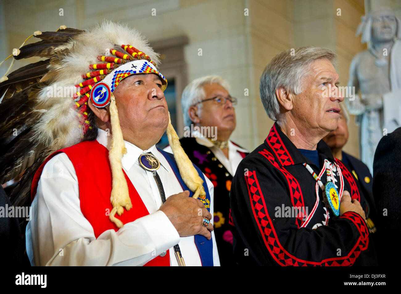 Representatives of Native American tribes stand during the Congressional Gold Medal Ceremony Honoring Native American Code Talkers in Emancipation Hall at the US Capitol Nov. 20, 2013 in Washington, DC . The Congressional Gold Medal was awarded to Native American code talkers for their valor and dedication during World War I and World War II. Stock Photo