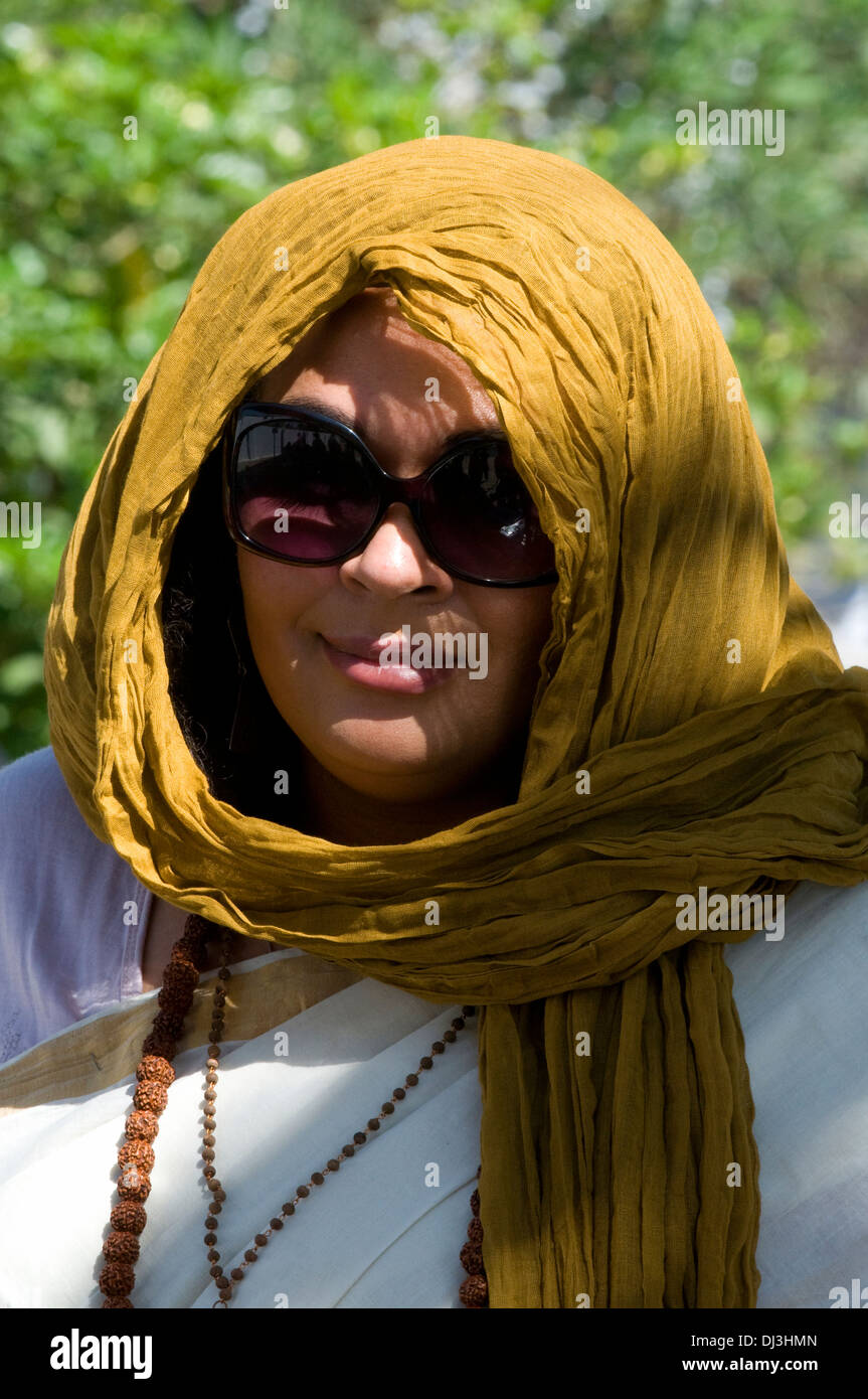 Portrait of woman wearing headscarf and sunglasses in India wearing rudraksha beads, small seed beads and sari Stock Photo