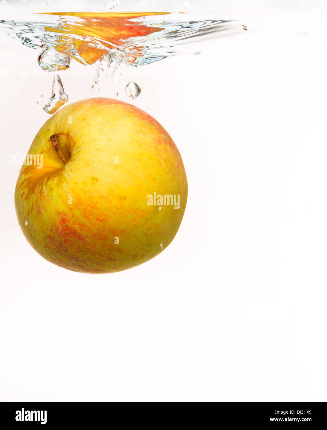 Red yellow apple in the water splash over white background. Healthy ...