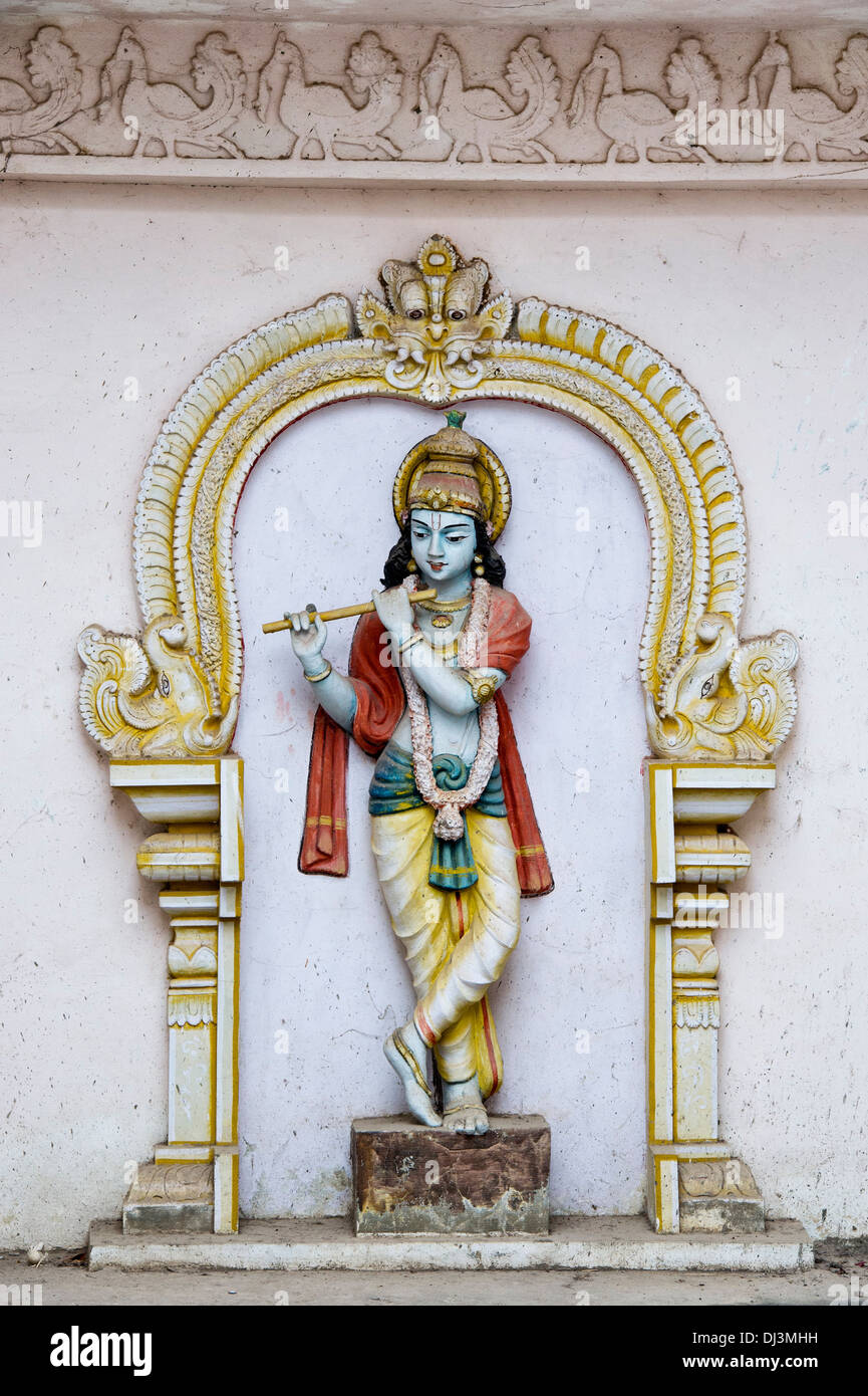 Old worn painted Krishna statue. Worshiped hindu Indian deity. Andhra Pradesh,  India Stock Photo