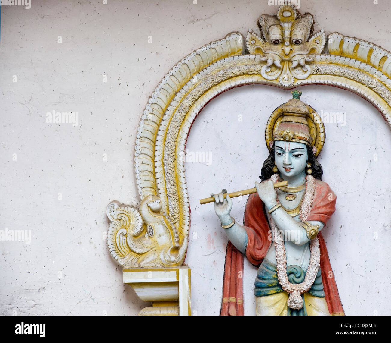 Old worn painted Krishna statue. Worshiped hindu Indian deity. Andhra Pradesh,  India Stock Photo