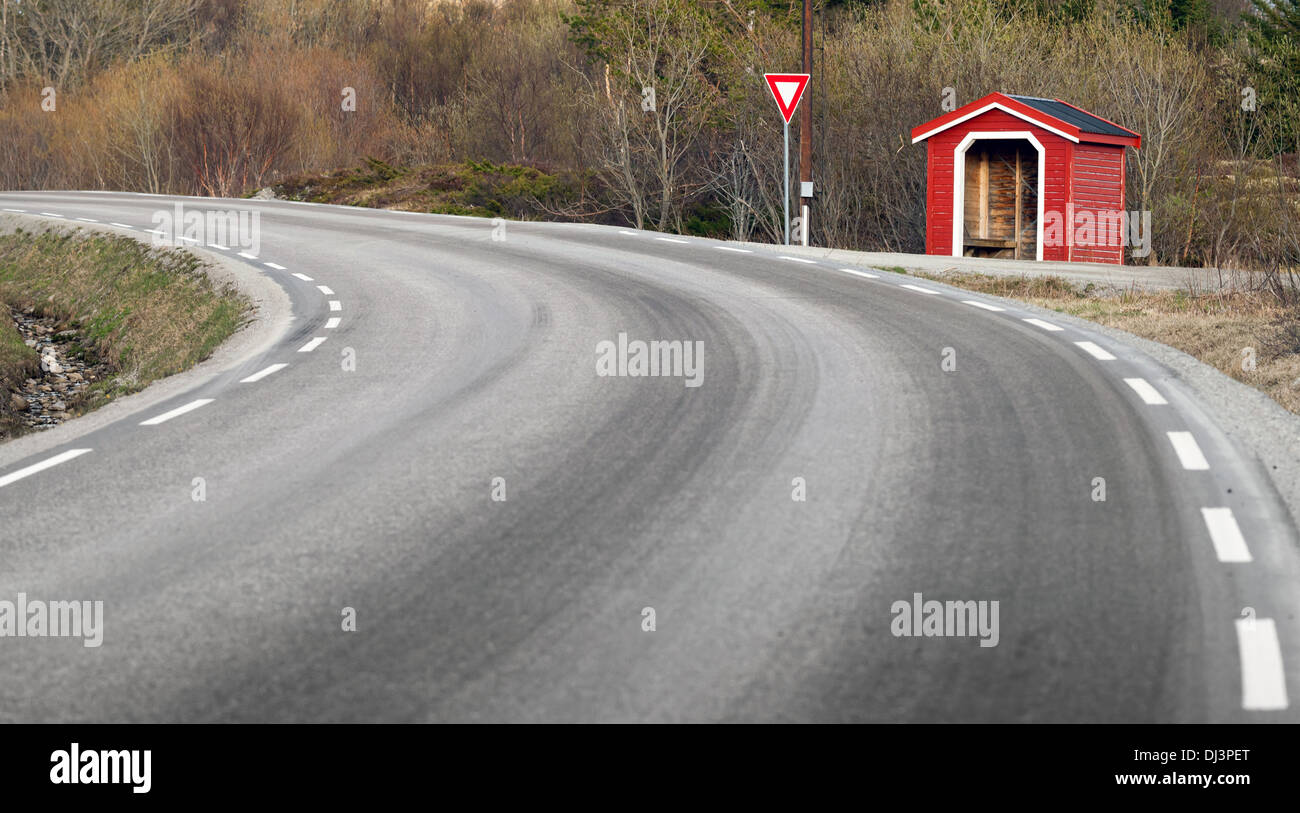 Small red wooden bus stop building in Norway Stock Photo