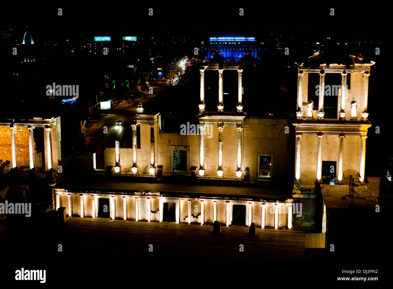 Roman ruins illuminated at night. In the background, the town of Plovdiv ( Bulgaria) Stock Photo