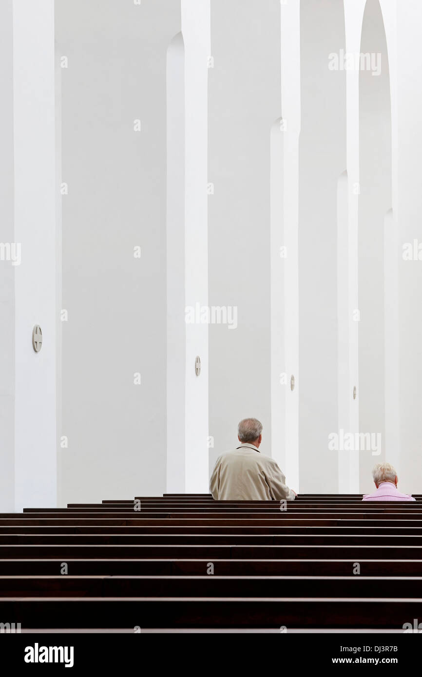 Moritzkirche, Augsburg, Germany. Architect: John Pawson, 2013. Detailed perspective with believer in pew. Stock Photo