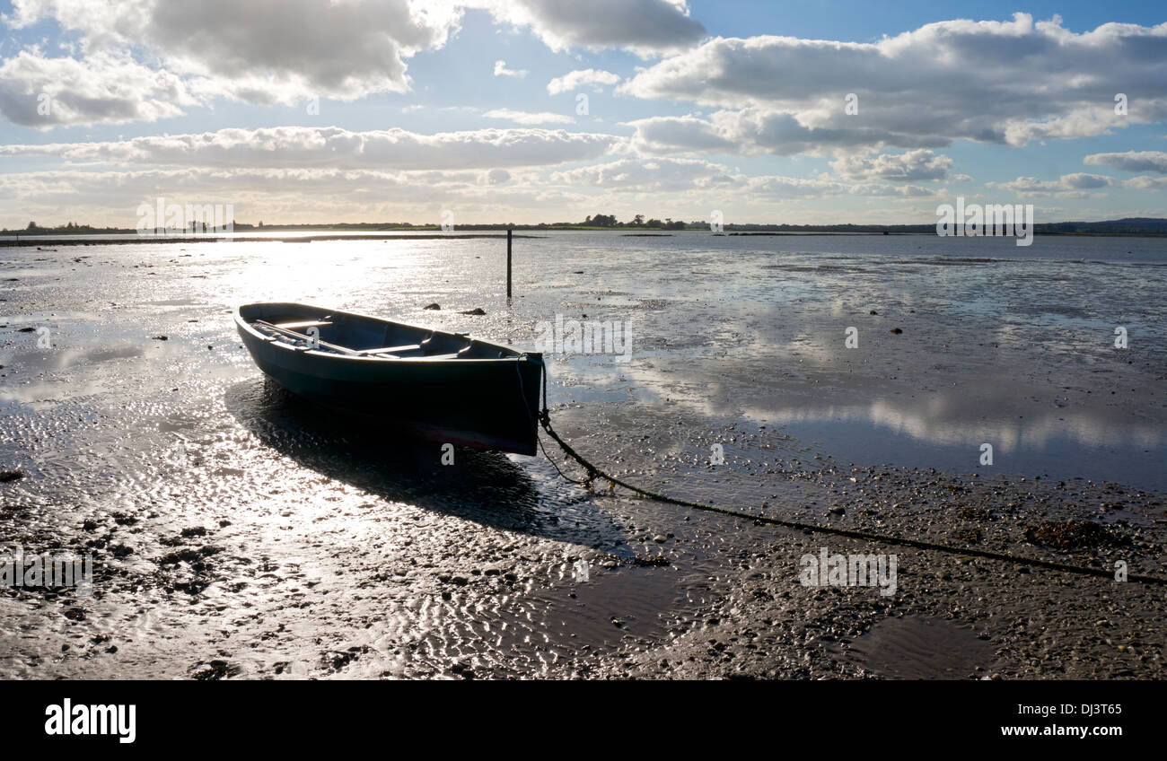 Old wooden rowing boat on mud flats at Wexford estuary, County Wexford, Ireland Stock Photo