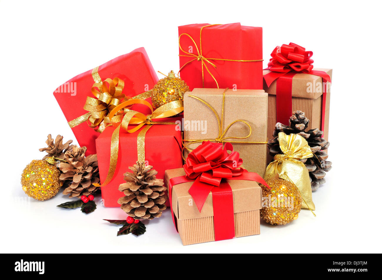 some christmas gifts wrapped with wrapping paper of different colors and ribbon bows, and some christmas ornaments on a white ba Stock Photo