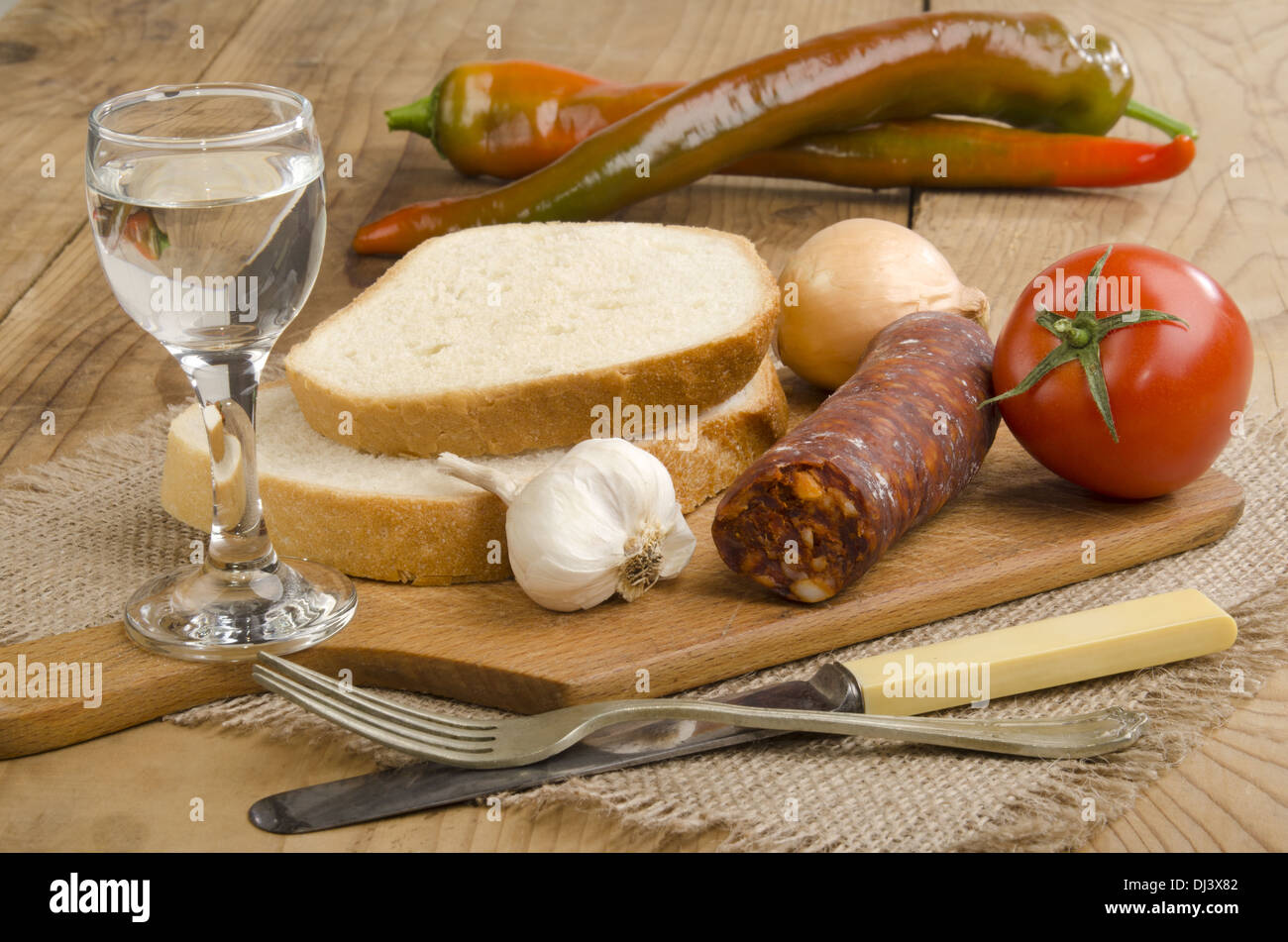 hungarian breakfast with home made kolbasz, palinka, tomato, garlic