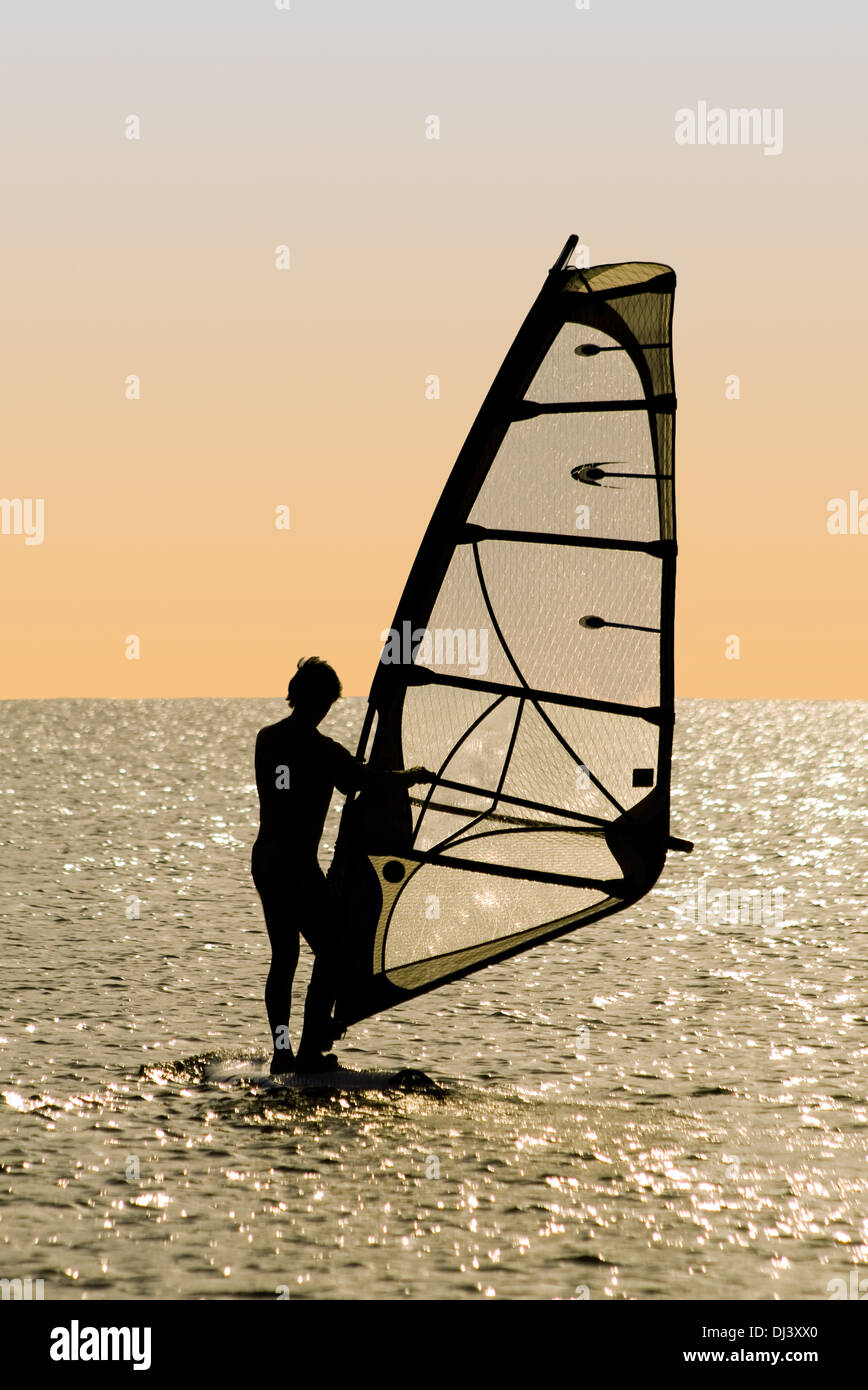 Silhouette of a windsurfer on waves of a gulf Stock Photo