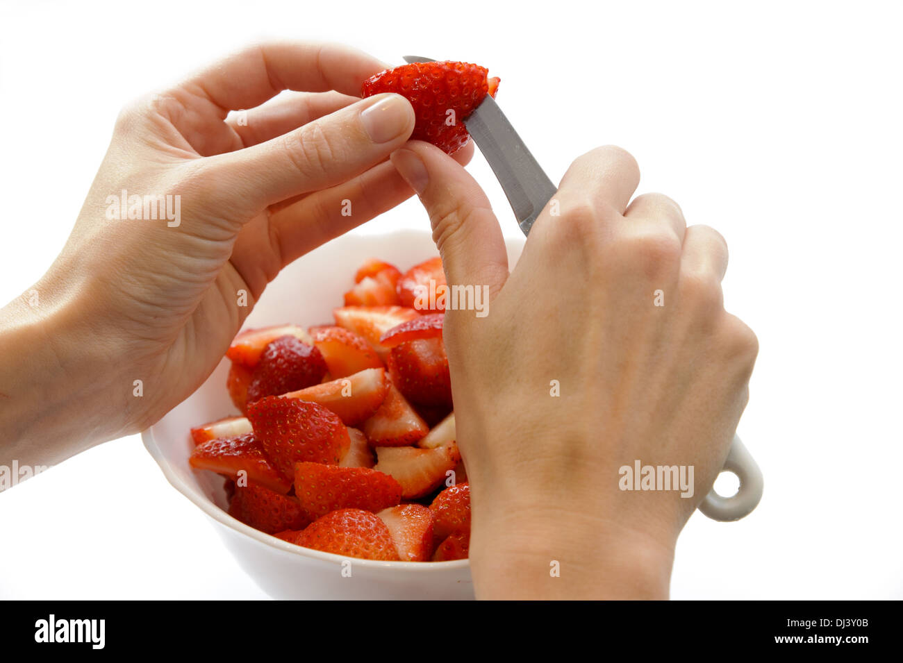 Woman's hands when cutting strawberries Stock Photo