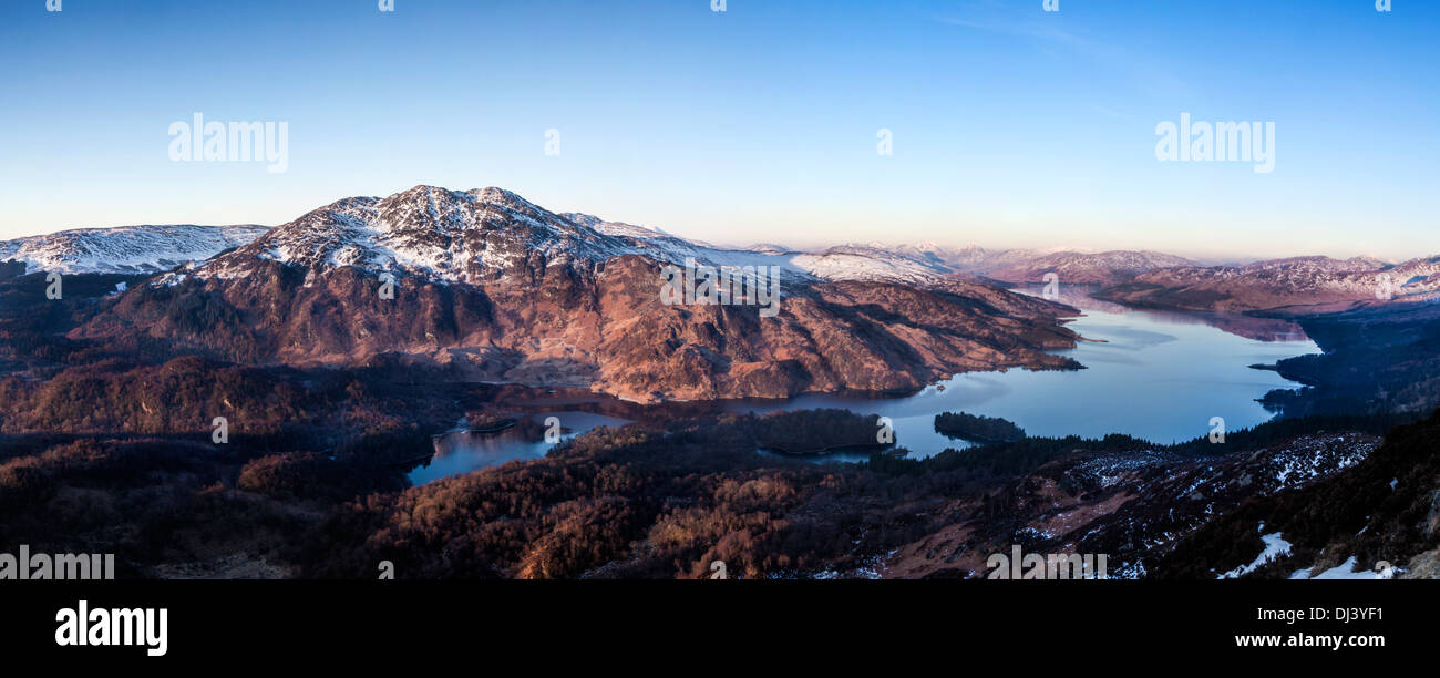 A scenic view across Loch Katrine to Ben Venue in the first rays of morning light. Stock Photo