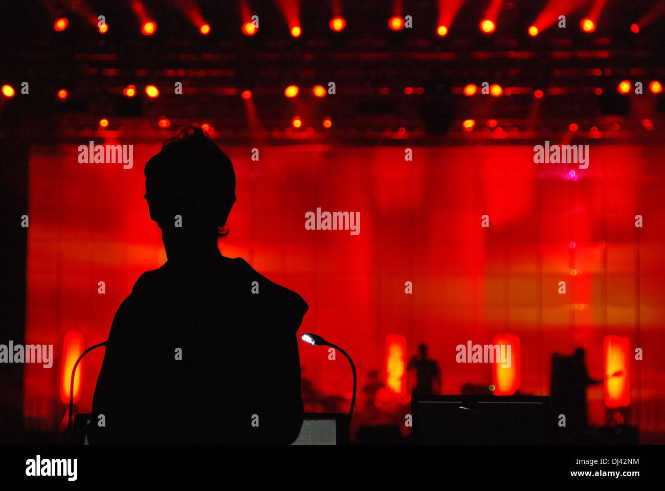 Silhouette of band's unrecognizable sound engineer from the back at the concert performance, shoot from the back Stock Photo