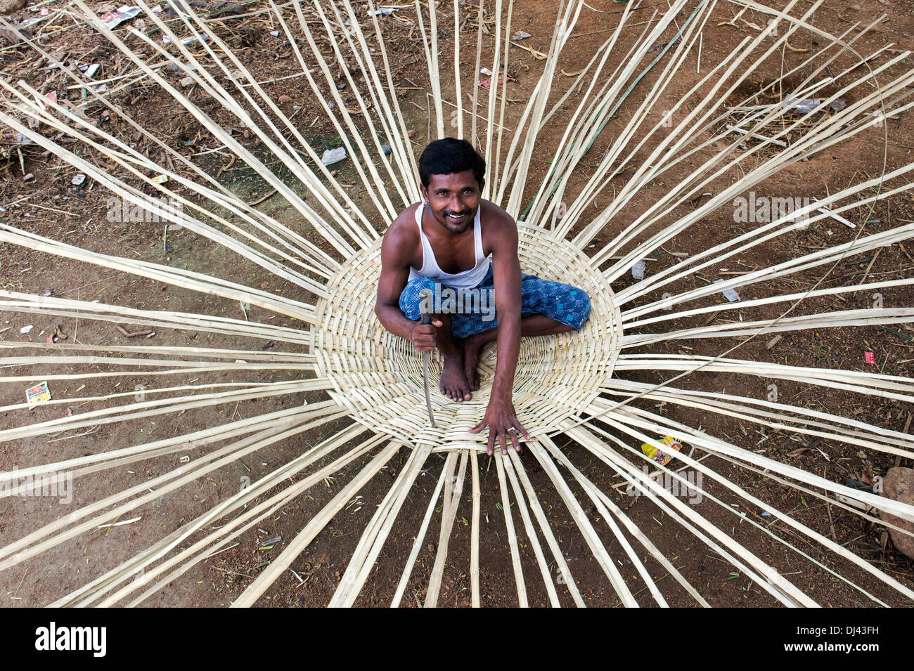 Indian man weaving a traditional goat pen from bamboo in a rural Indian village. Andhra Pradesh, India Stock Photo