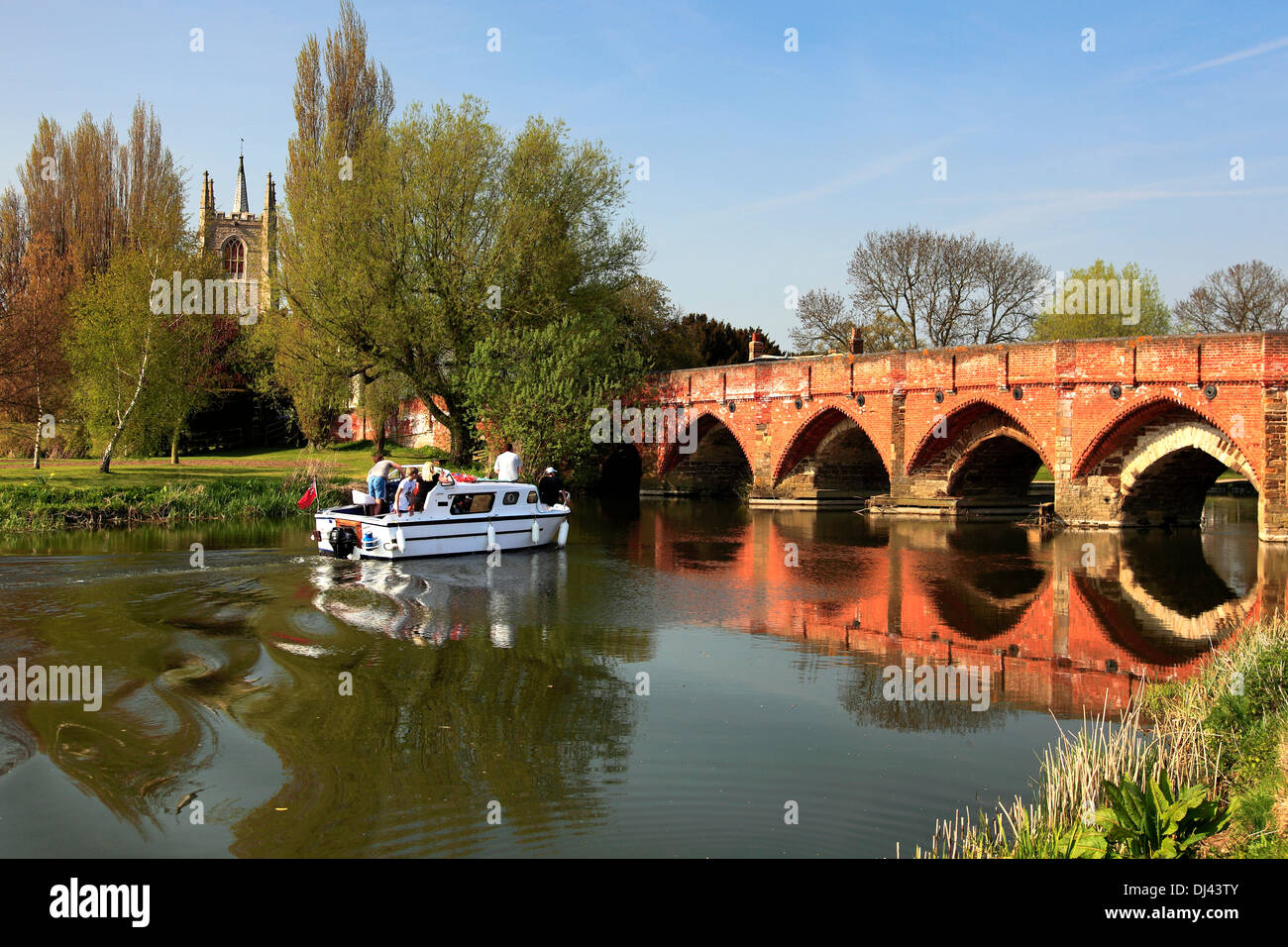 Boat and bridge over the river Great Ouse, Great Barford village, Bedfordshire, England, UK Stock Photo