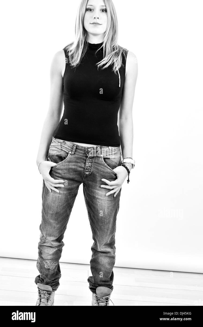 Young woman with hands in pocket Stock Photo - Alamy