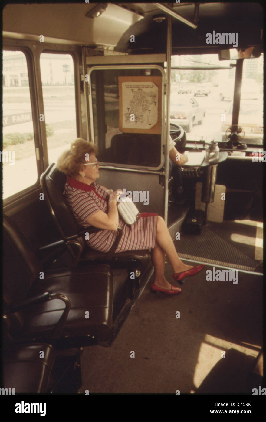 WOMAN RIDING ALONE ON A DIAL A RIDE RADIO DISPATCHED DOOR-TO-DOOR BUS SERVICE IN HADDONFIELD, NEW JERSEY. IT BEGAN IN . 743 Stock Photo