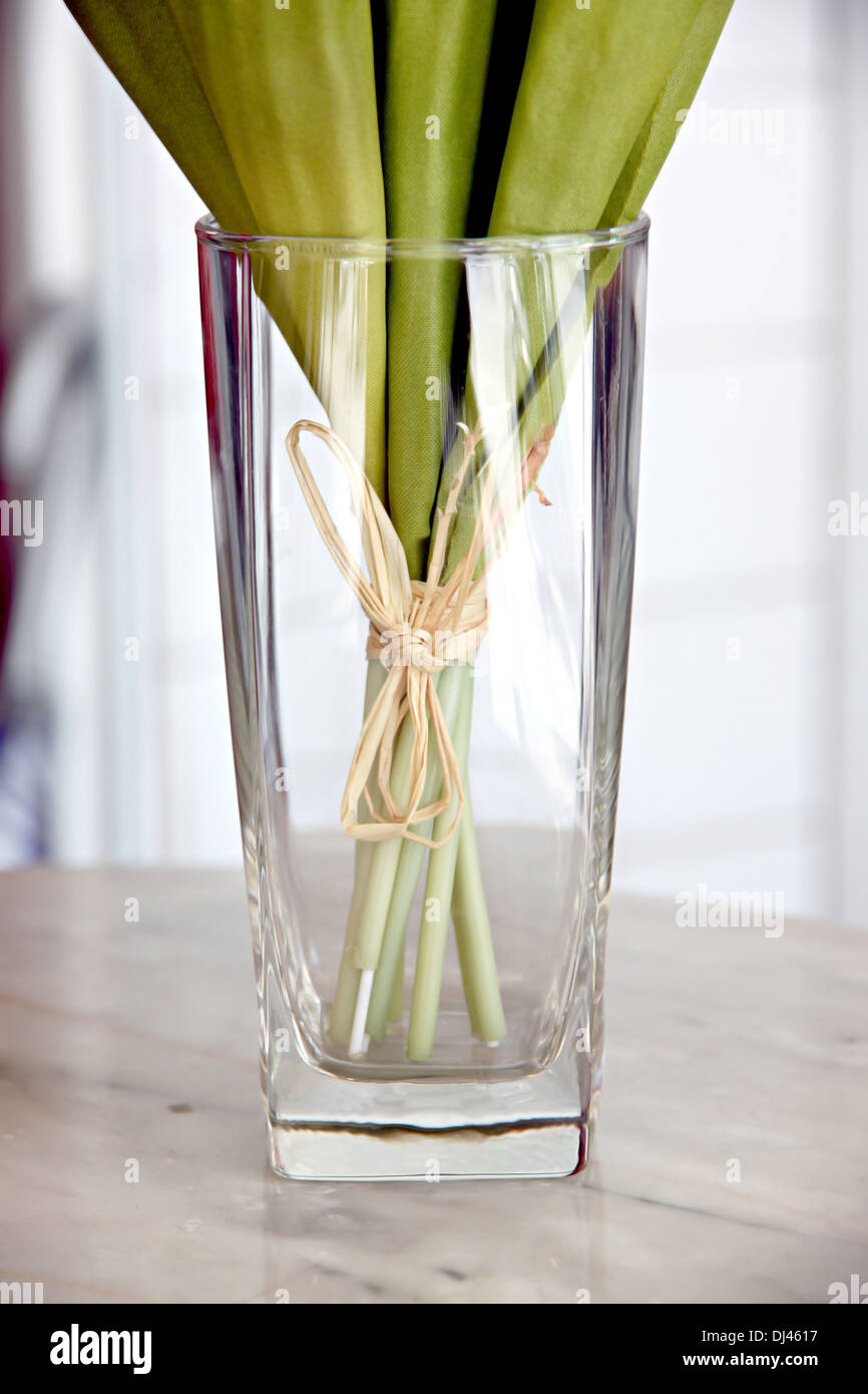Insert the stems of the flowers into the glass. Stock Photo
