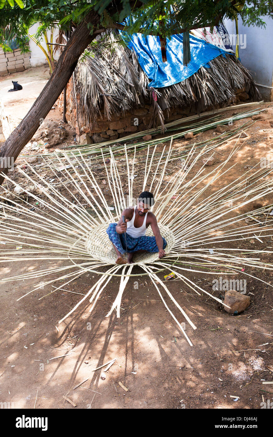 Indian man weaving a traditional goat pen from bamboo in a rural Indian village. Andhra Pradesh, India Stock Photo