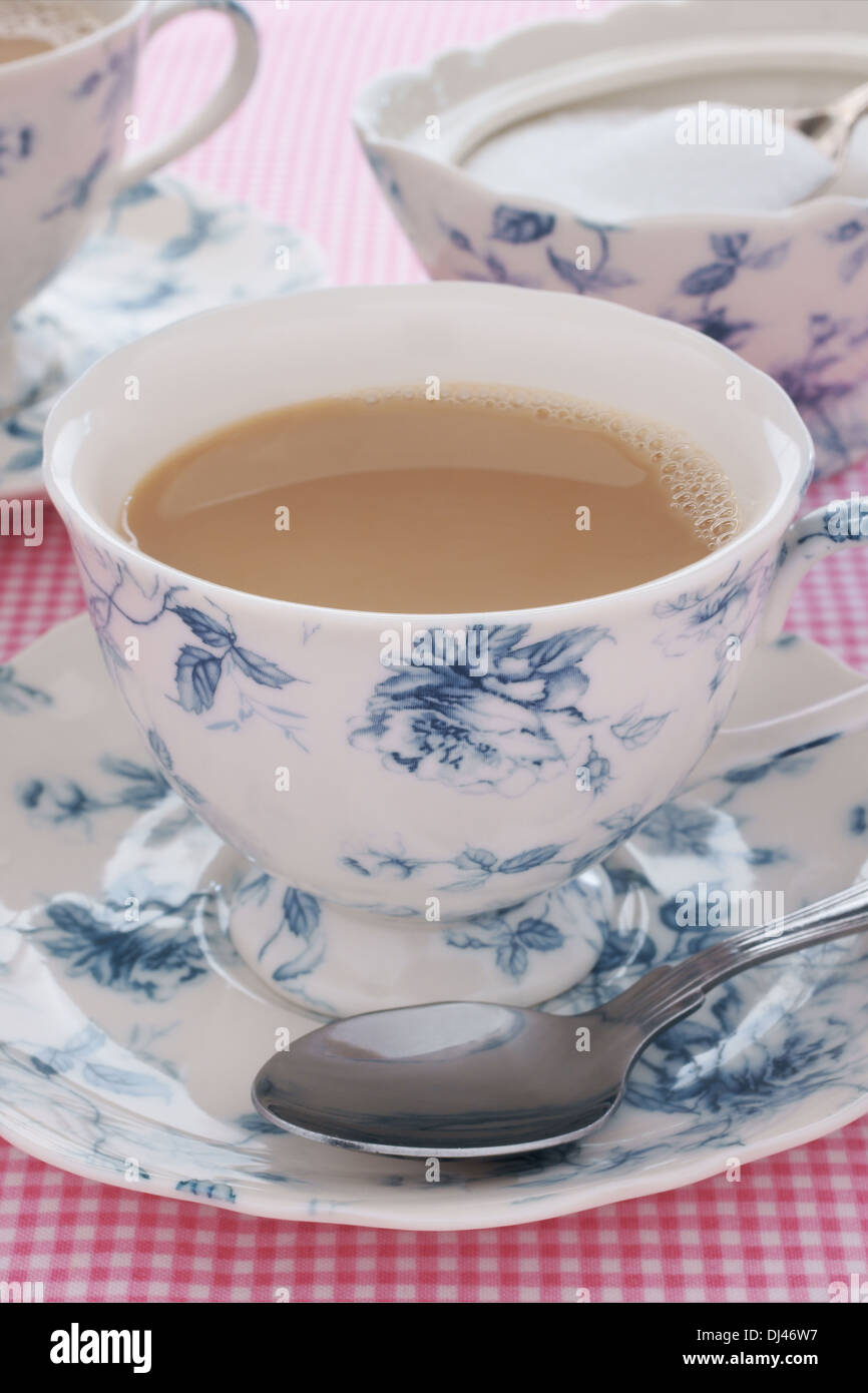 Tea served with milk in a floral bone china tea service Stock Photo