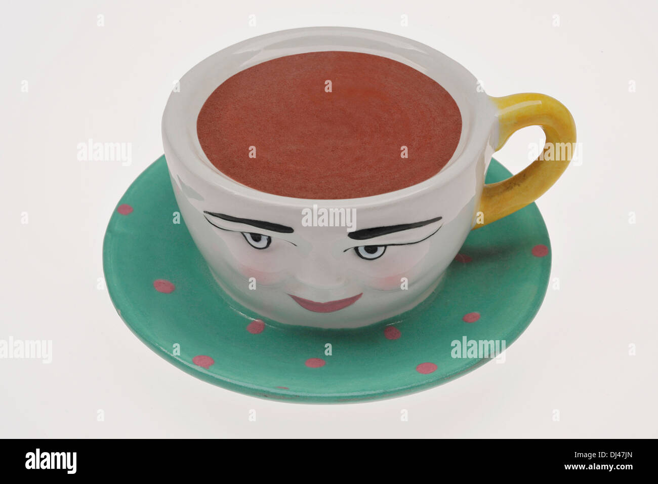 China/ceramic tea cup with smiling face. Stock Photo