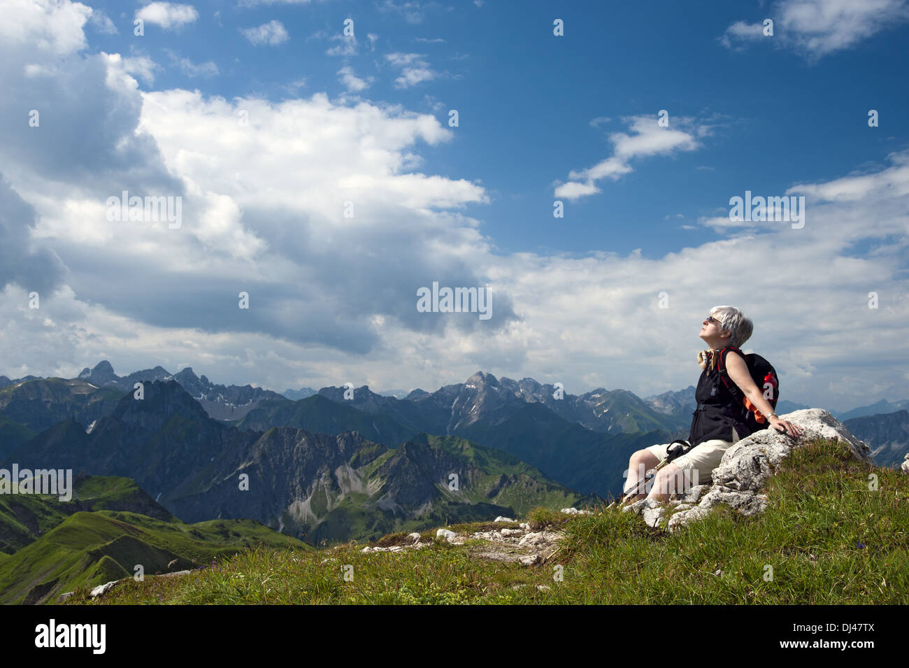 Woman sitting on a rock Stock Photo