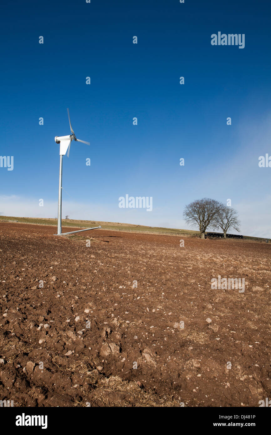 Wind turbine against a bright blue sky on a farm Stock Photo - Alamy
