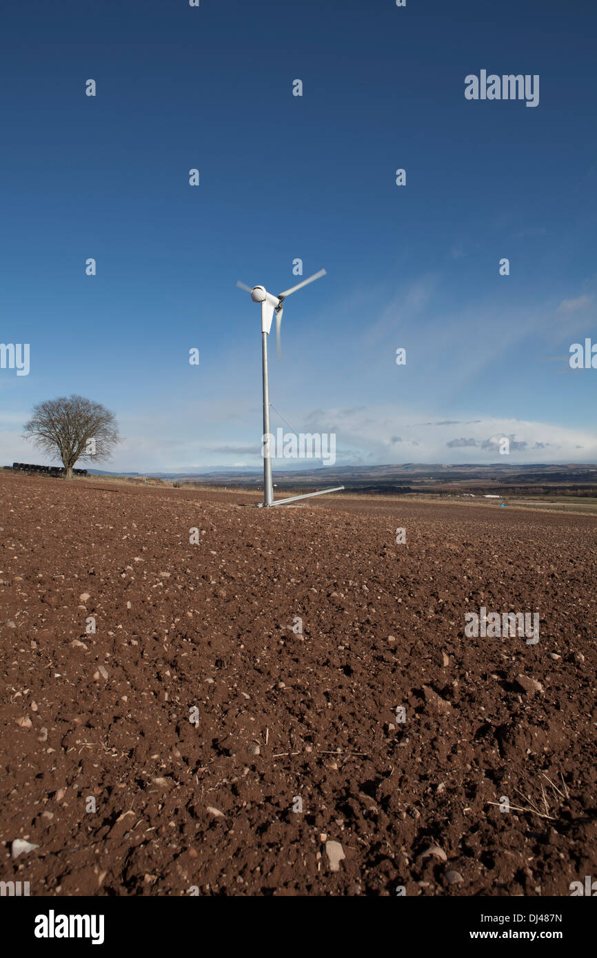 Wind turbine against a bright blue sky on a farm Stock Photo - Alamy