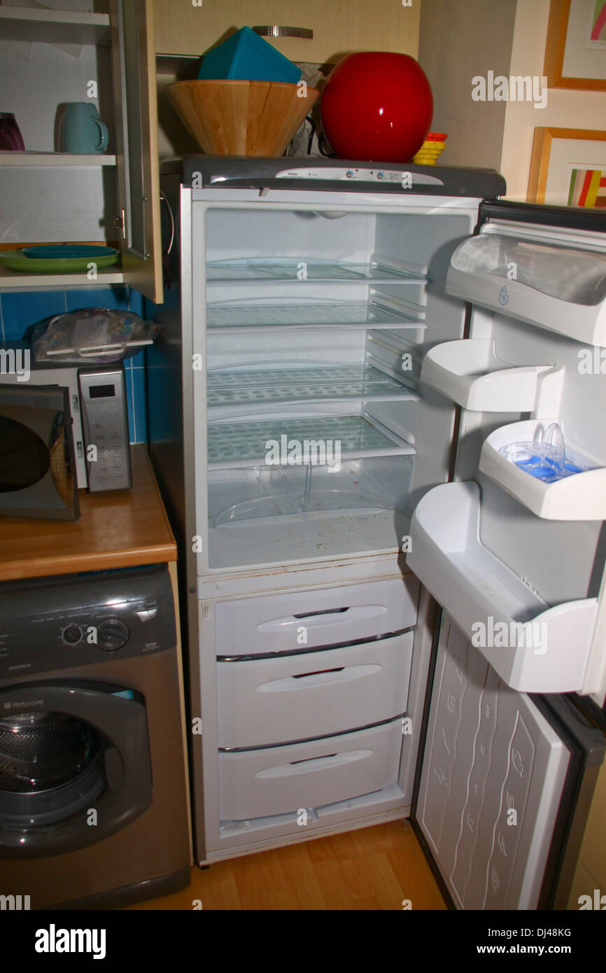 Empty fridge freezer in domestic kitchen Stock Photo