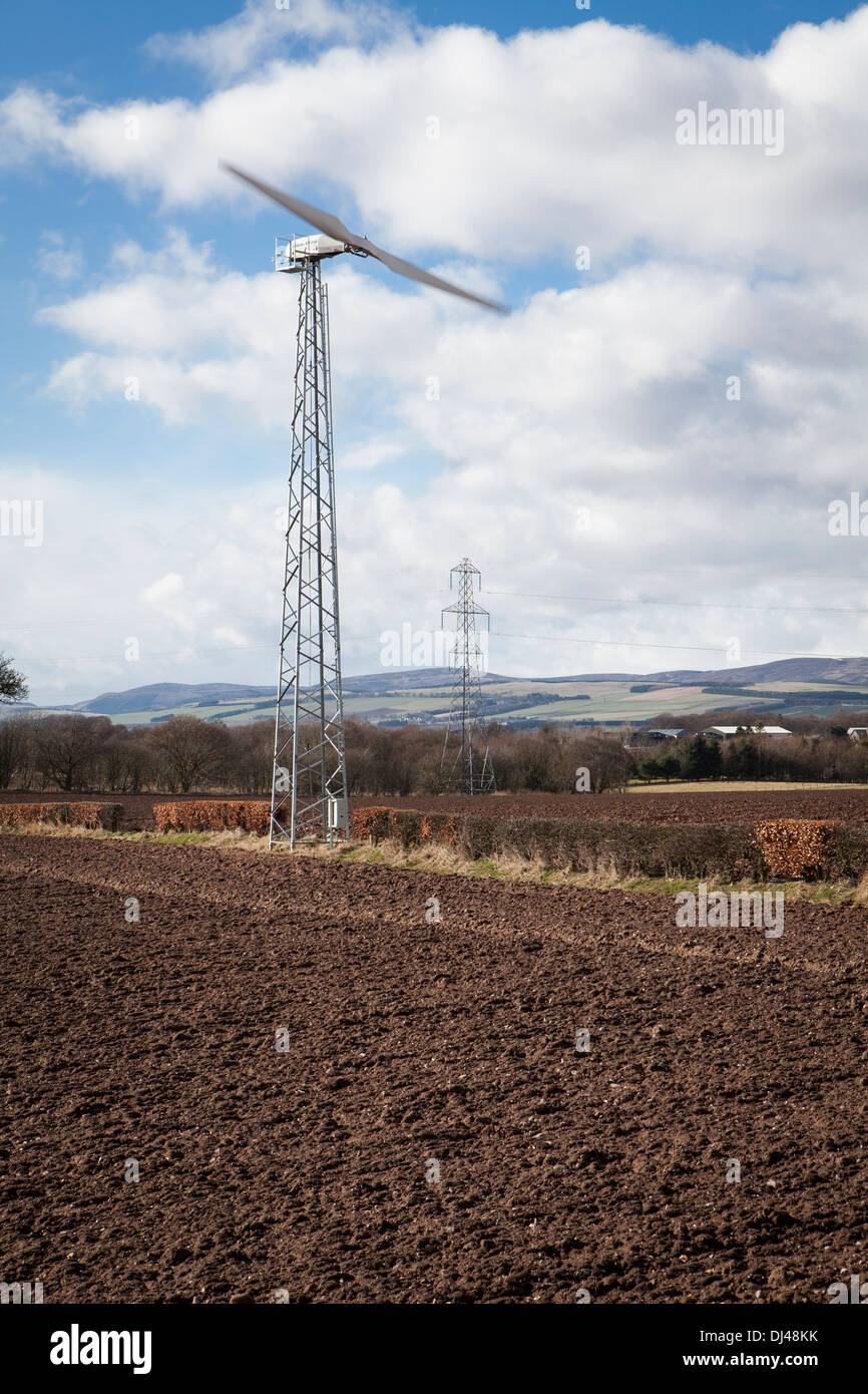 Wind turbine against a bright blue sky on a farm Stock Photo - Alamy