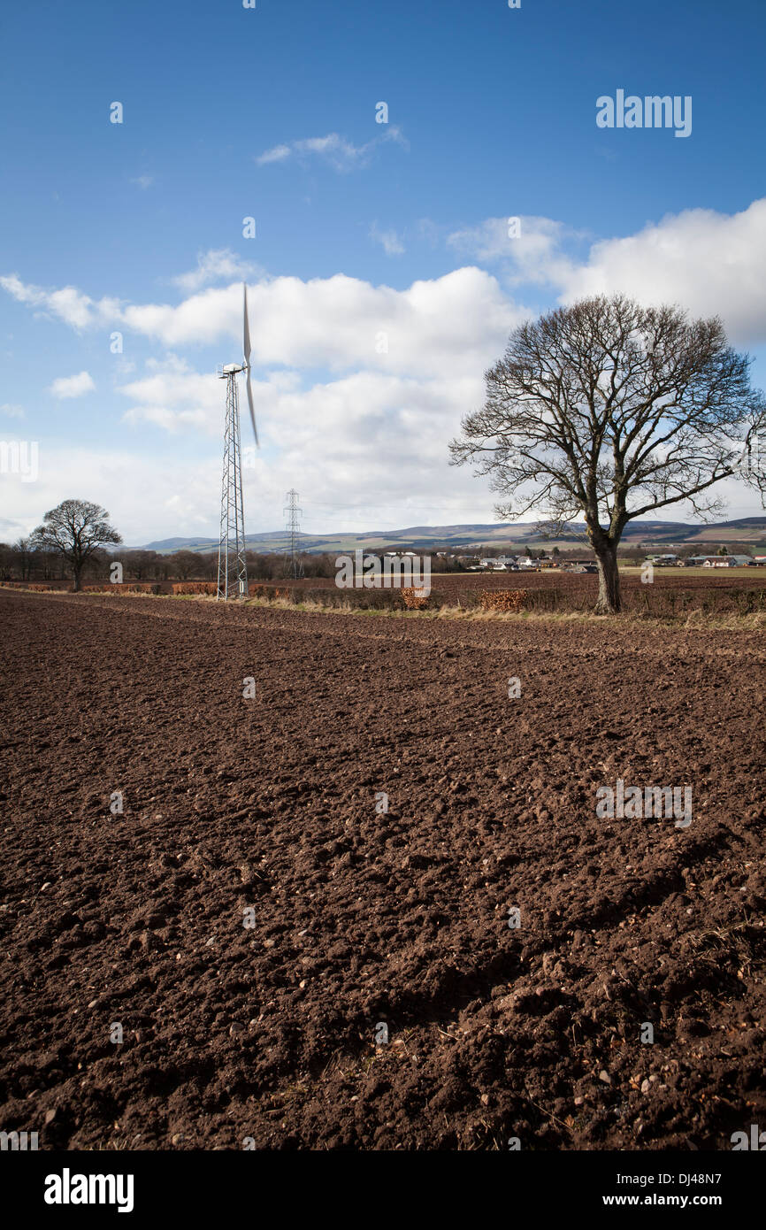 Wind turbine against a bright blue sky on a farm Stock Photo - Alamy