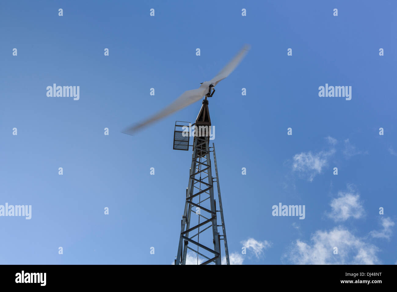 Wind turbine against a bright blue sky on a farm Stock Photo - Alamy