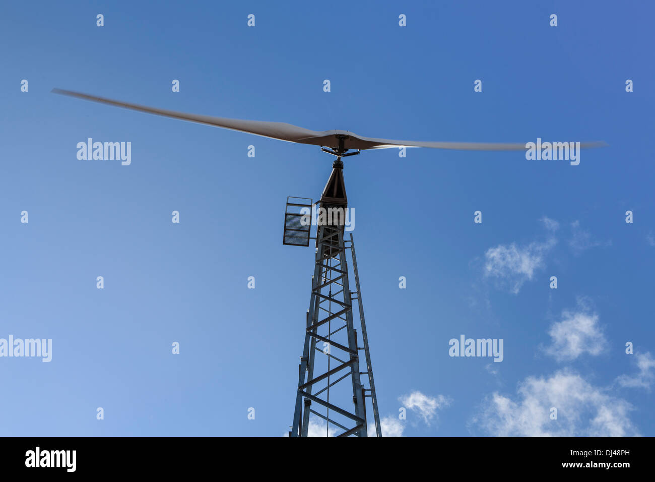 Wind turbine against a bright blue sky on a farm Stock Photo - Alamy