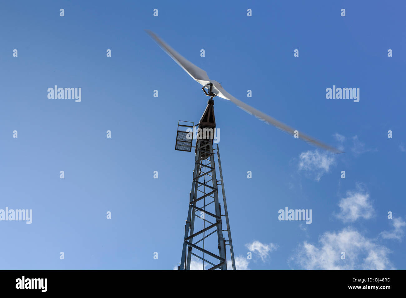 Wind turbine against a bright blue sky on a farm Stock Photo - Alamy