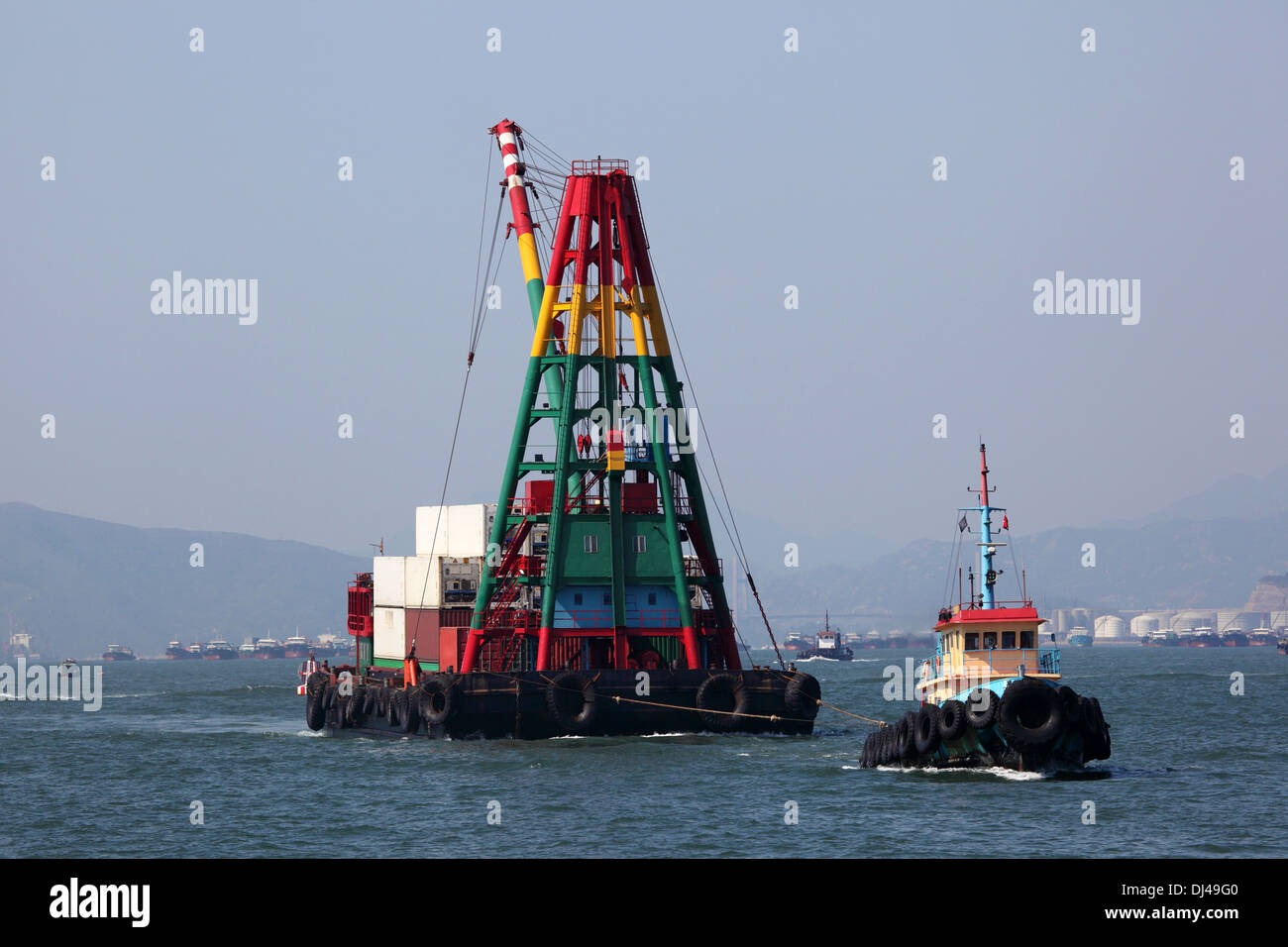 Tugboat with a crane barge in the harbour of Hong Kong Stock Photo