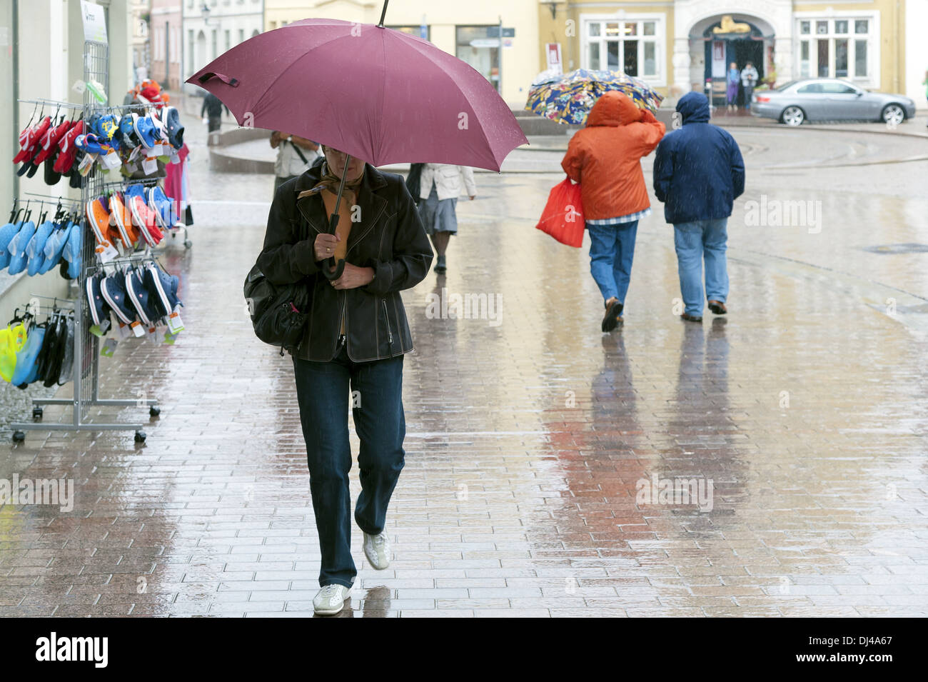 Woman in the rain with an umbrella Stock Photo
