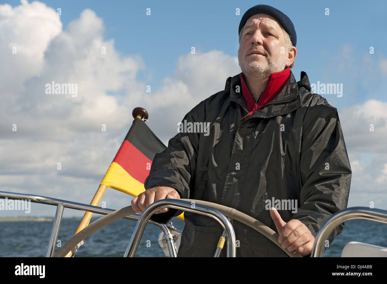 Skipper at the helm of his yacht Stock Photo